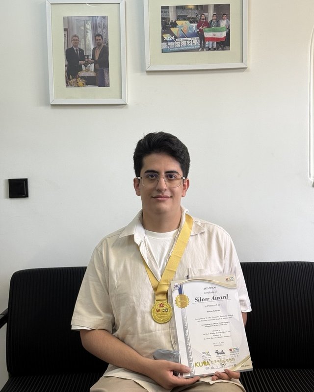 Raman Nafarieh holding the WICO 2025 Silver Award certificate and medal