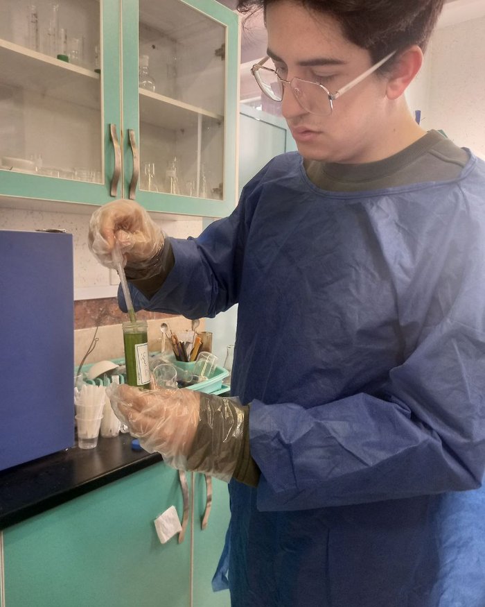 Raman Nafarieh drawing a sample from a prepared plant extract